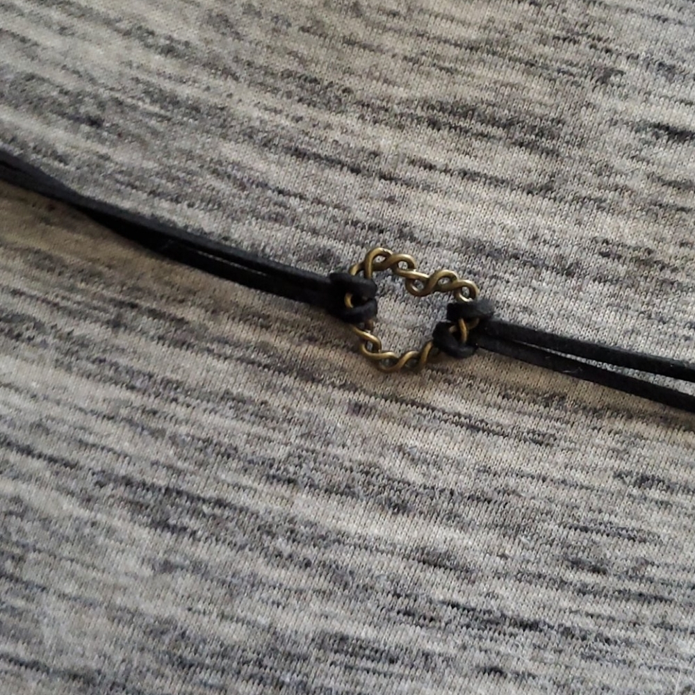 Black leather choker with metal, gold heart.